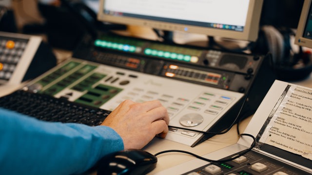 Ein Mann bedient an einem Technik-Arbeitsplatz einen Computer